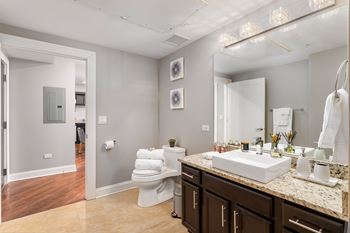 Bathroom with a sink and a toilet and a mirror